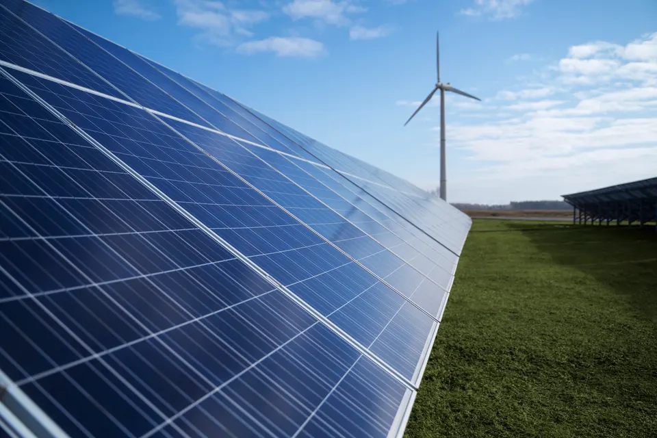 Solar panels and wind turbines generating renewable energy